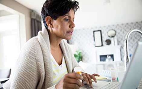 A woman connects with a UVA doctor via telemedicine video appointment.